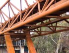 The new Deakin University Burwood pedestrian bridge uses REDCOR® weathering steel to deliver a practical, paint-free structure requiring minimal maintenance compared with conventional structural steel.